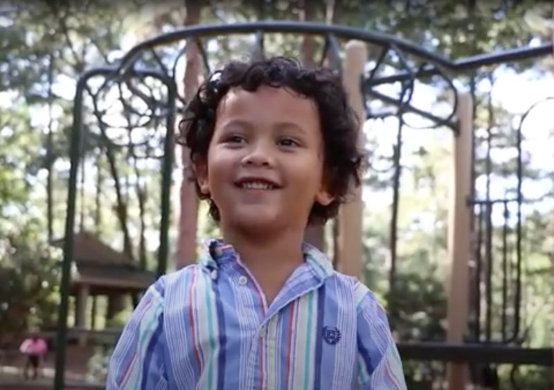 little boy smiling on playground